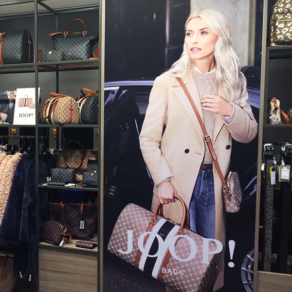 Lena Gercke in front of a JOOP banner in store