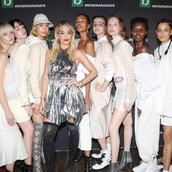 Rita Ora with models in front of the Deichmann logo wall