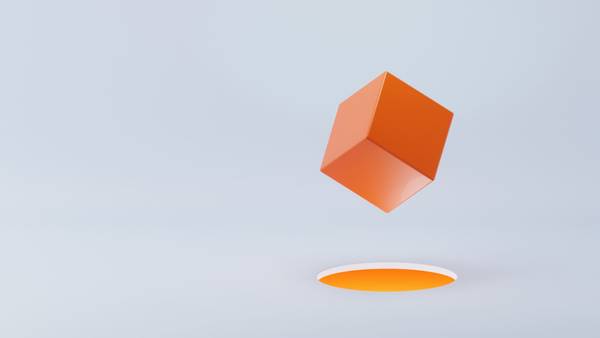 Orange cube floating above its shadow against a light grey background.