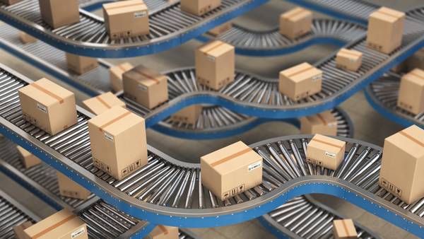 Cardboard boxes on branching roller conveyors in a distribution centre.